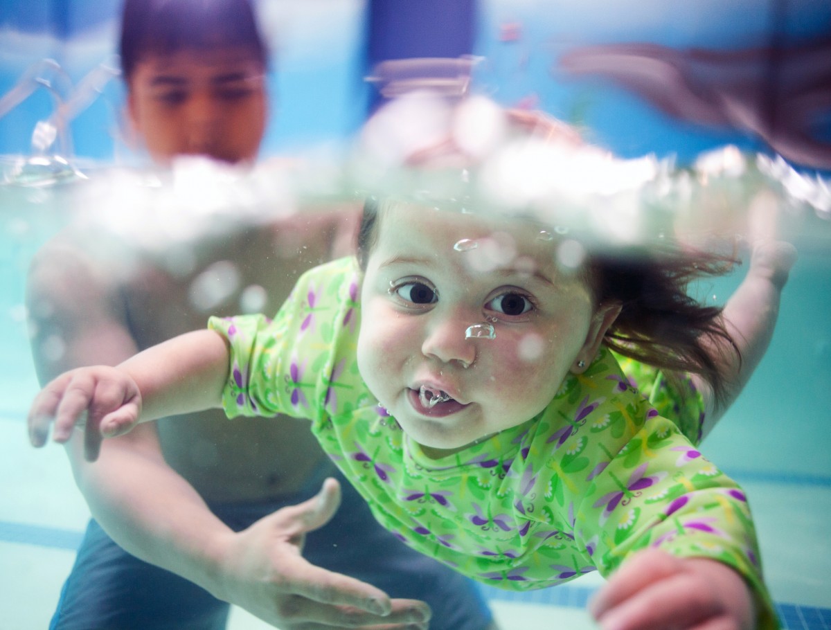 Caitlin Gillen, 18 months old, of Farmingdale, learns to swim during a private lesson at Saf-T-Swim of Bellmore with instructor Guiseppe DiVanna, 22, of Levittown. (July 1, 2013)
 Photo: Newsday / Jeffrey Basinger