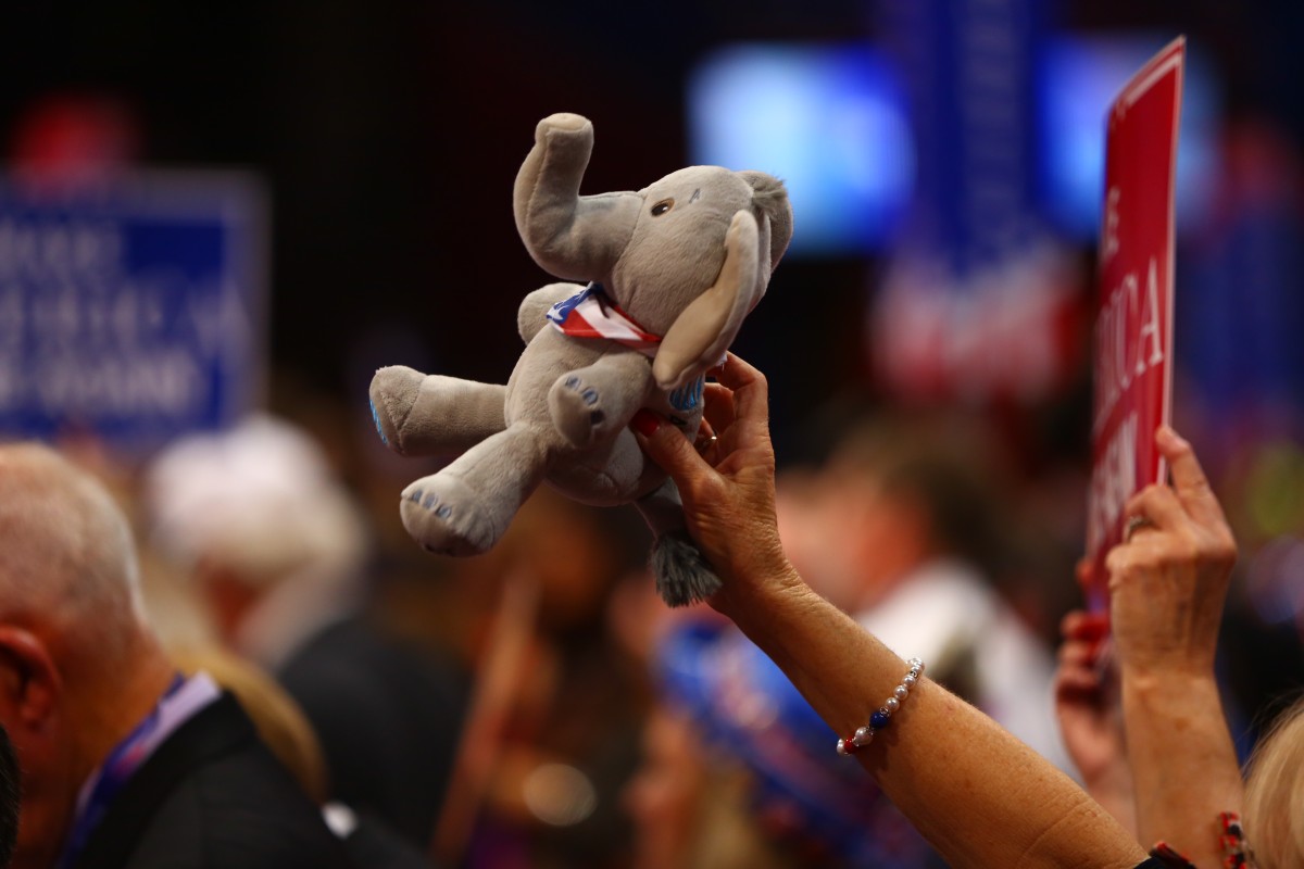 A delegate from Texas holds a stuffed elephant on the fourth day of the 2016 Republican National Convention in Cleveland, OH.