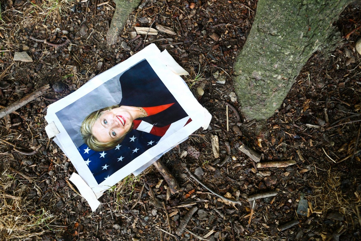 A photo of Hillary Clinton lays beside a tree outside the Democratic National Convention at the Wells Fargo Center in Philadelphia, July 27, 2016.