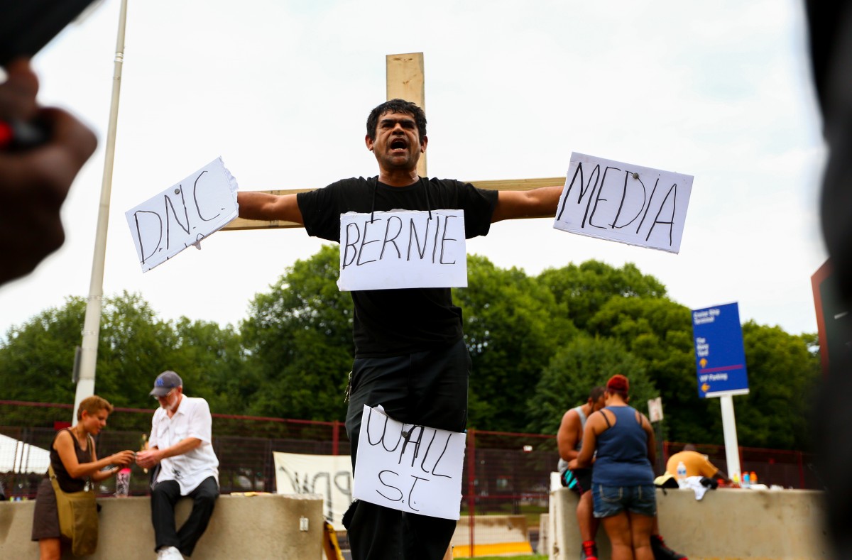 Martin Altamirano, originally from Honduras but living in Atlanta, calls out against the DNC while demonstrating a mock crucifixion on the last day of the 2016 Democratic National Convention in Philadelphia, July 28.